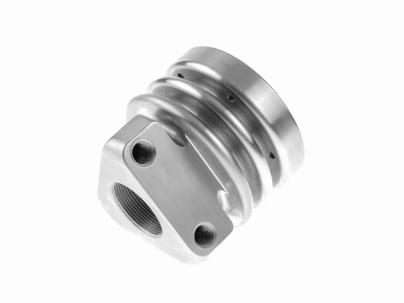Stainless mill-turn part with grooves, threaded port and milled mounting face